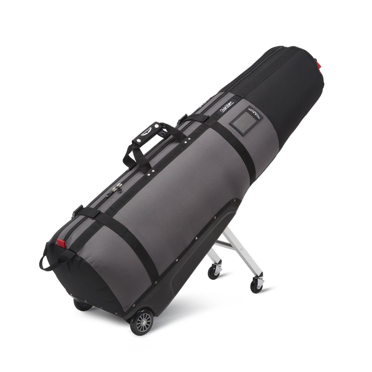 Grey and black ski bag with wheels and a handle, leaning against a white surface.