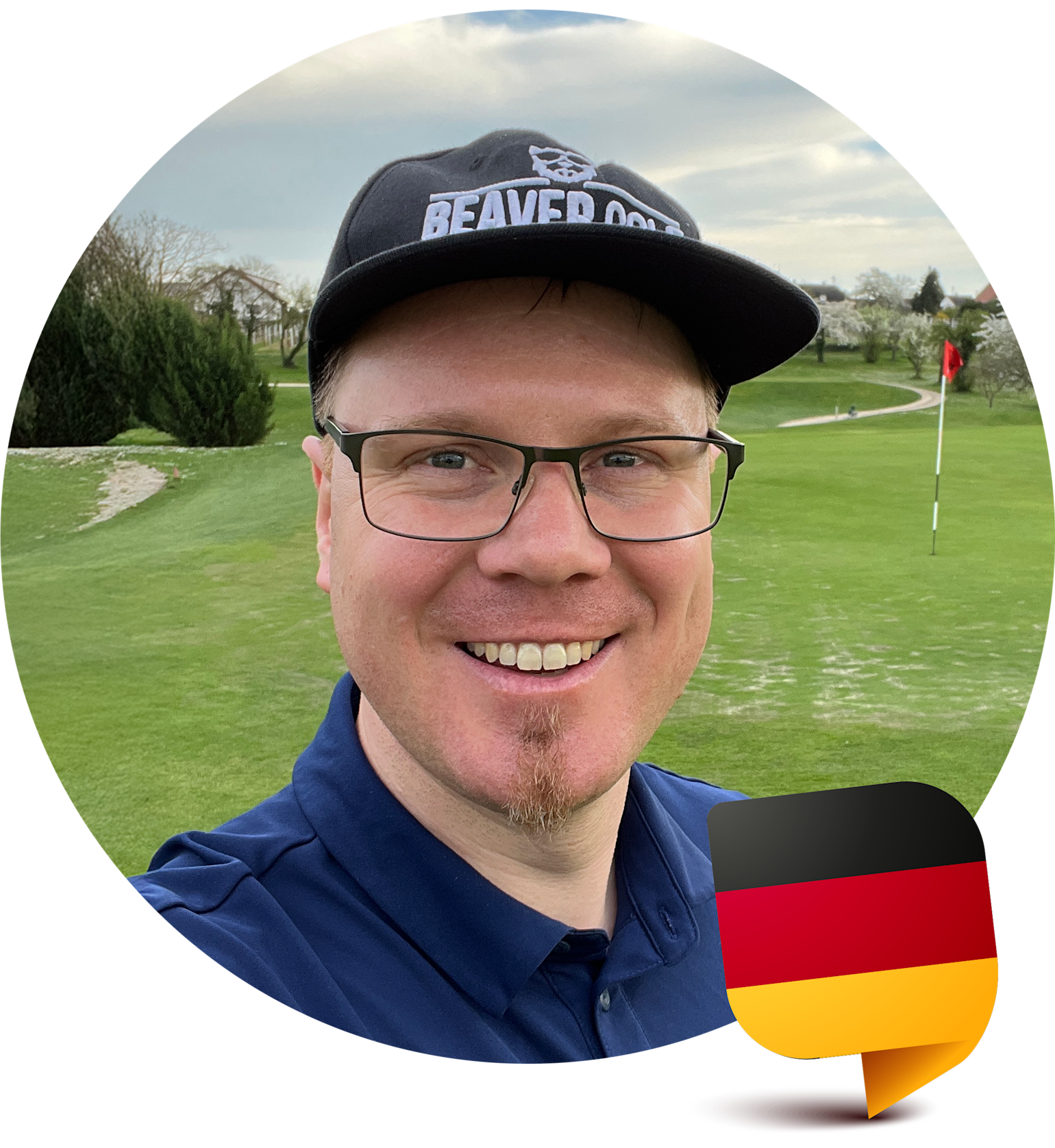 Leende person med glasögon och keps med texten "BEAVER CODE" på en golfbana, tysk flaggikon i hörnet.